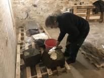 The Cunaide Stone after being moved inside the Heritage Centre. Sue is seen here applying paper pulp to absorb the moisture.